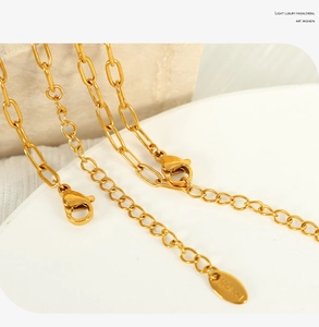 Close-up of gold butterfly necklace chain with lobster clasp and adjustable extension link