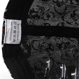 Detailed view of skull baseball cap interior showing 100% polyester wash label and stitching