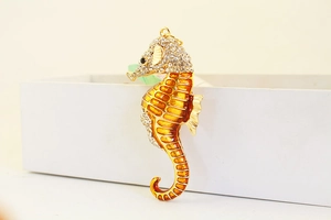 Detailed view of seahorse keychain with yellow enamel inlay and sparkling crystal rhinestones