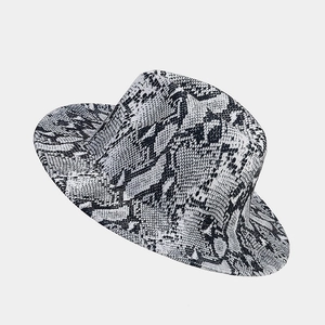 Detail of elegant wide brim fedora hat featuring bold black and white snakeskin print pattern