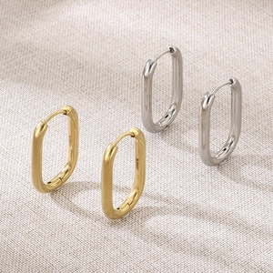 Detail view of U-shaped oval hoop earrings in polished gold and silver finishes