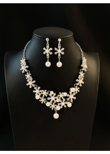 Floral pearl jewelry set with crystals displayed on a black mannequin for an elegant look
