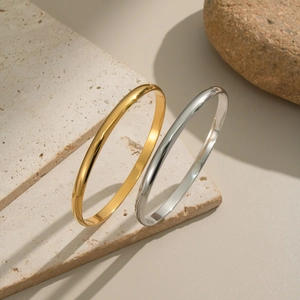 Minimalist gold and silver stainless steel bangles set with a polished mirror finish