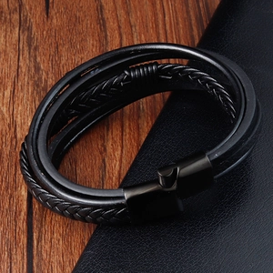 Detail shot of multi-layer black braided leather bracelet with black metal clasp