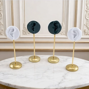 Modern resin ear-shaped jewelry display stand with golden metal rods in green and white