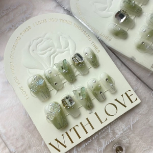 Handmade press-on nails with green gradient, 3D floral accents and shimmering rhinestones