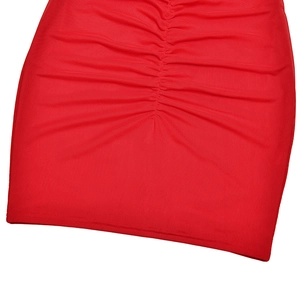 Detail of red mesh dress showing elegant pleated texture and high-quality fabric finish