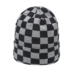 Close-up of black and grey checkerboard knit beanie texture and rolled edge details