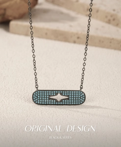 Macro view of gunmetal star pendant featuring micro-pave blue synthetic turquoise stones