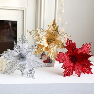 Sparkling artificial poinsettia flowers in silver, gold, and red for Christmas decoration