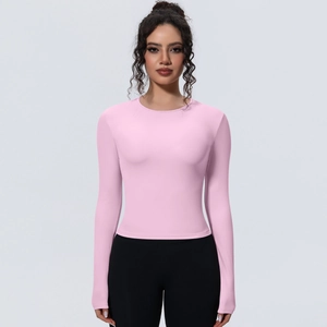 Détail d'un t-shirt de yoga rose à manches longues avec coupe ajustée et tissu sportif