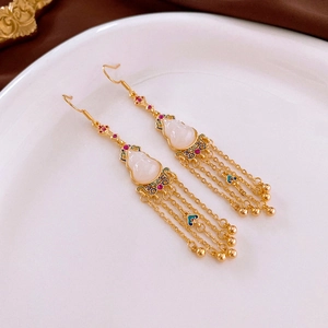 Detail of gold-plated gourd tassel earrings with white stone and colorful gemstones