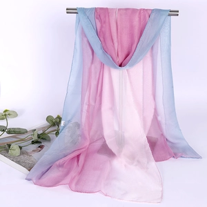 Close-up of lightweight gradient pink and blue chiffon scarf draped over a metal bar