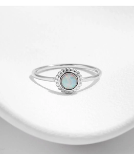 Macro shot of silver sunflower ring with iridescent opal center and retro beaded details