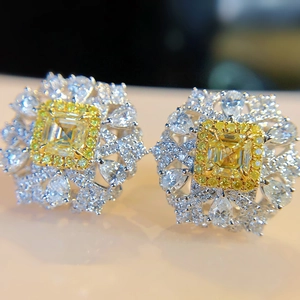 Asscher cut yellow gemstone stud earrings with elaborate floral halo setting