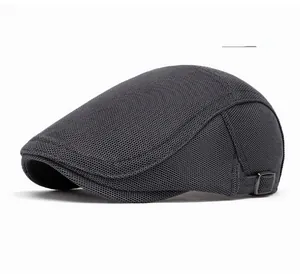 Detail of dark gray mesh beret featuring a metallic adjustable side buckle and breathable fabric