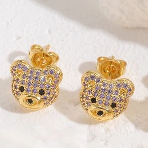 Detailed macro view of cute bear earrings with purple and black zircon inlay