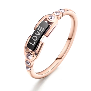 Rose gold titanium ring with black LOVE inlay and small diamonds on a white background
