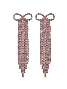 Macro detail of long tassel earrings with rose pink gradient rhinestones and bow design