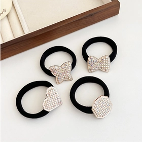Detail showing elastic hair ties with rhinestone heart and butterfly charms