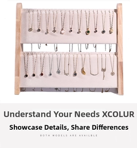 Close-up of double-layer wooden jewelry stand with beige velvet racks and necklace slots