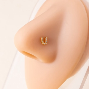 U-shaped gold nose ring with micro-paved zircons shown on a silicone model nose