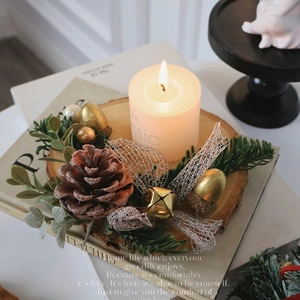 Christmas log candle holder with pine cones, golden bells and green pine branches