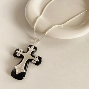 Vintage resin cross pendant necklace with silver floral relief on a box chain
