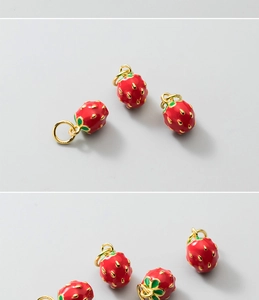 Close-up of red strawberry enamel charms with gold plating for jewelry making
