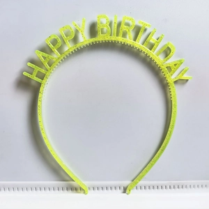 Detail shot of neon yellow HAPPY BIRTHDAY headband with glitter on a white background