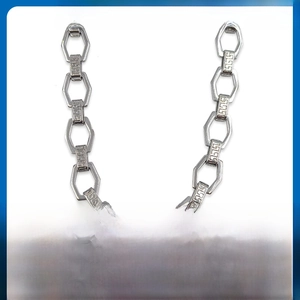 Close-up of silver stainless steel chain with hexagonal links and geometric engravings