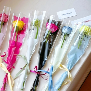 Assorted colorful single stem rose bouquets in Love You transparent gift bags