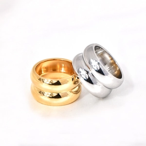 Macro detail of gold and silver minimalist double-layered wide stainless steel rings