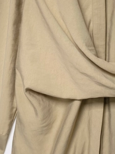 Close-up of beige twill fabric texture with soft drapes and high-quality fiber detail