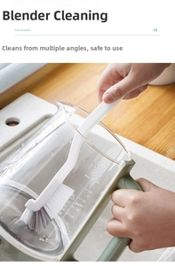 L-shaped long handle brush cleaning the inner wall of a glass blender jar effectively