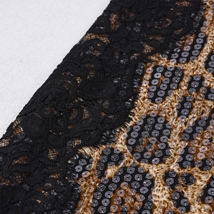 Macro detail of leopard print fabric with black lace stitching and shiny sequins