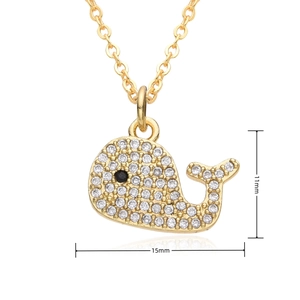 Macro view of gold whale pendant with white zircon stones measuring 15mm by 11mm