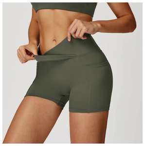 Detail of high-waisted olive green yoga shorts featuring side pocket for phone storage