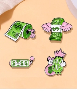 Set of 4 gold and green dollar themed enamel pins with cartoon money motifs and wings