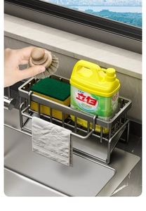 Close-up of dark grey metal sink caddy holding detergent sponge and towel rack