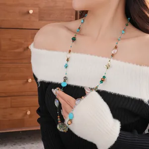 Ethnic beaded long necklace featuring turquoise stones and a golden butterfly pendant