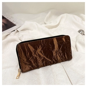 Detail of dark brown pleated long wallet with zipper on white fabric background