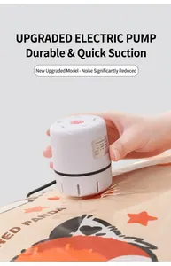 Action shot of a compact white electric pump deflating a vacuum storage bag.