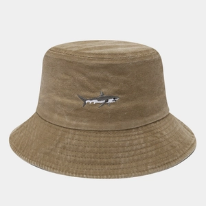Close-up of khaki canvas bucket hat with detailed shark embroidery and stitched brim