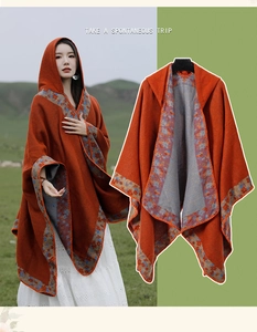 Detail of ethnic knit hooded poncho in orange with blue patterns for travel outfits