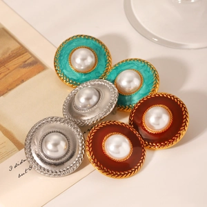 Macro detail of French vintage round enamel earrings with pearl center and gold woven border