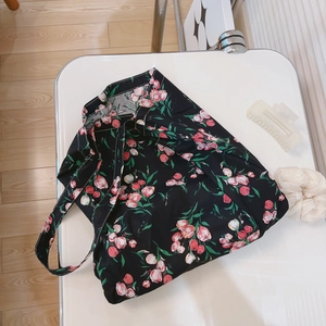 Floral canvas tote bag with pink tulips on black fabric, casual crossbody shoulder style