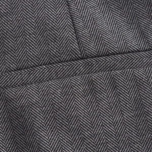 Macro shot of dark grey herringbone wool fabric showing thick texture and weave pattern