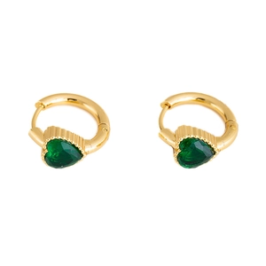 Detail of gold huggie earrings featuring heart-shaped emerald green zircon stones