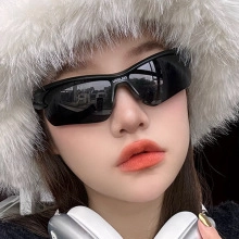 Close-up of black one-piece cycling sunglasses on a model for outdoor sports fashion